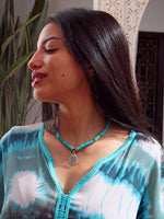 Turquoise and silver necklace worn