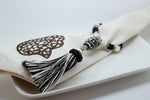 SET OF SIX DARK BROWN & CREAM EMBROIDERED NAPKINS AND BEADED TASSEL RINGS
