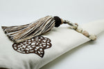 SET OF SIX BROWN & CREAM EMBROIDERED NAPKINS AND TASSEL RINGS