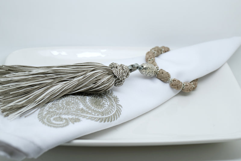 SET OF SIX  BEIGE & CREAM EMBROIDERED NAPKINS AND TASSEL RINGS