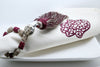 SET OF EIGHT DARK RED & BEIGE EMBROIDERED NAPKINS AND TASSEL RINGS